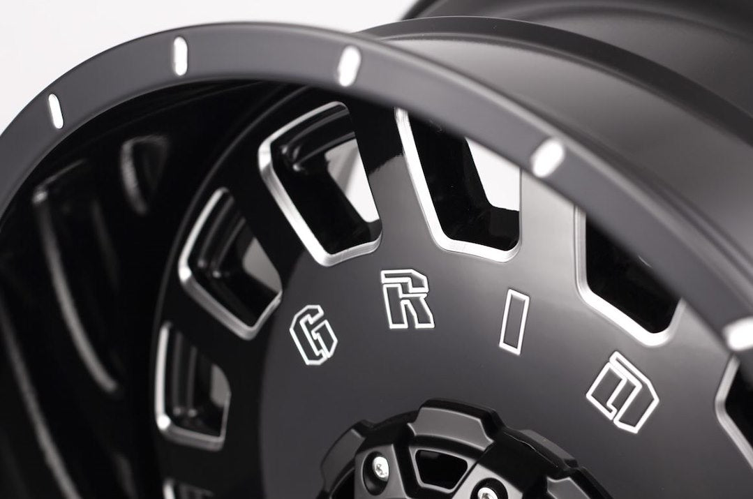 Product of Grid Wheels 18x9 Black With Natural Accents Wheel - 5x5.12 Bolt Pattern 