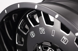 Product of Grid Wheels 18x9 Black With Natural Accents Wheel - 5x5.12 Bolt Pattern 